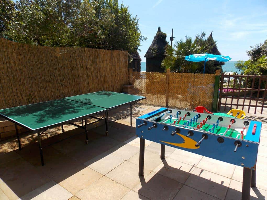 Play area with ping-pong table and foosball table at Bagno Le Cannucce.