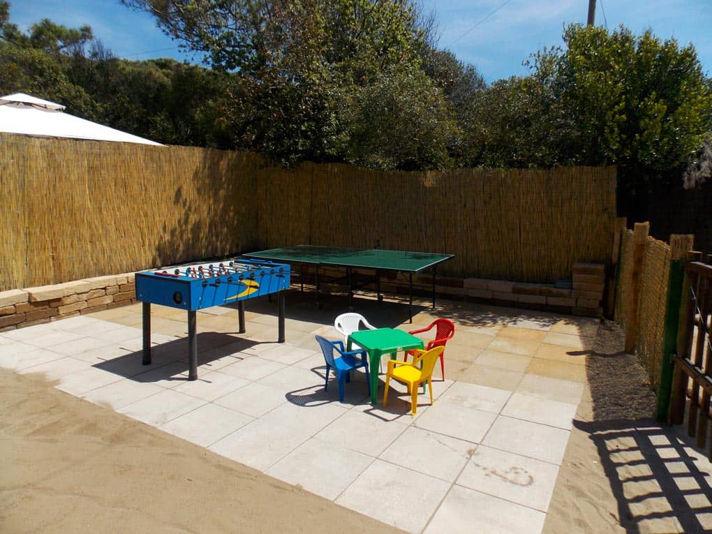 Outdoor play area with ping pong table and table soccer.