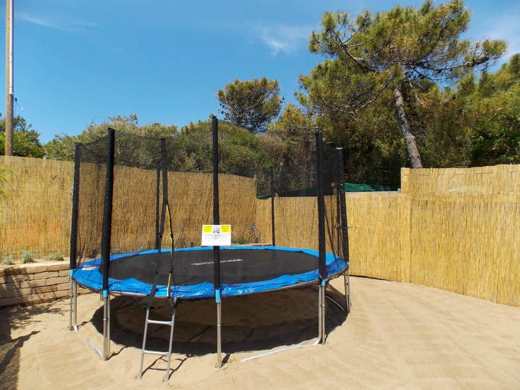Bungee trampoline in outdoor play area at Bagno Le Cannucce.