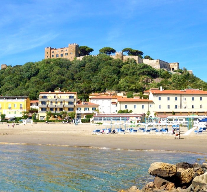 View of Castiglione della Pescaia, beach, sea and castle.
