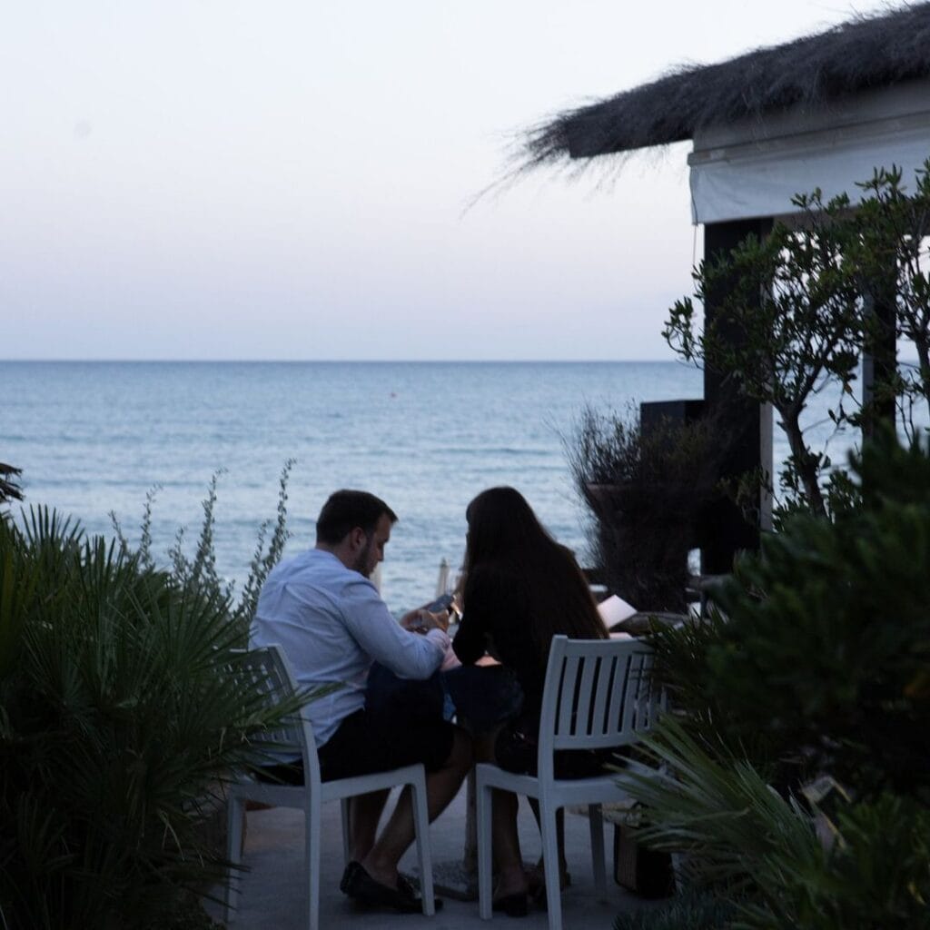 Couple at sunset in the beachfront restaurant Le Cannucce.